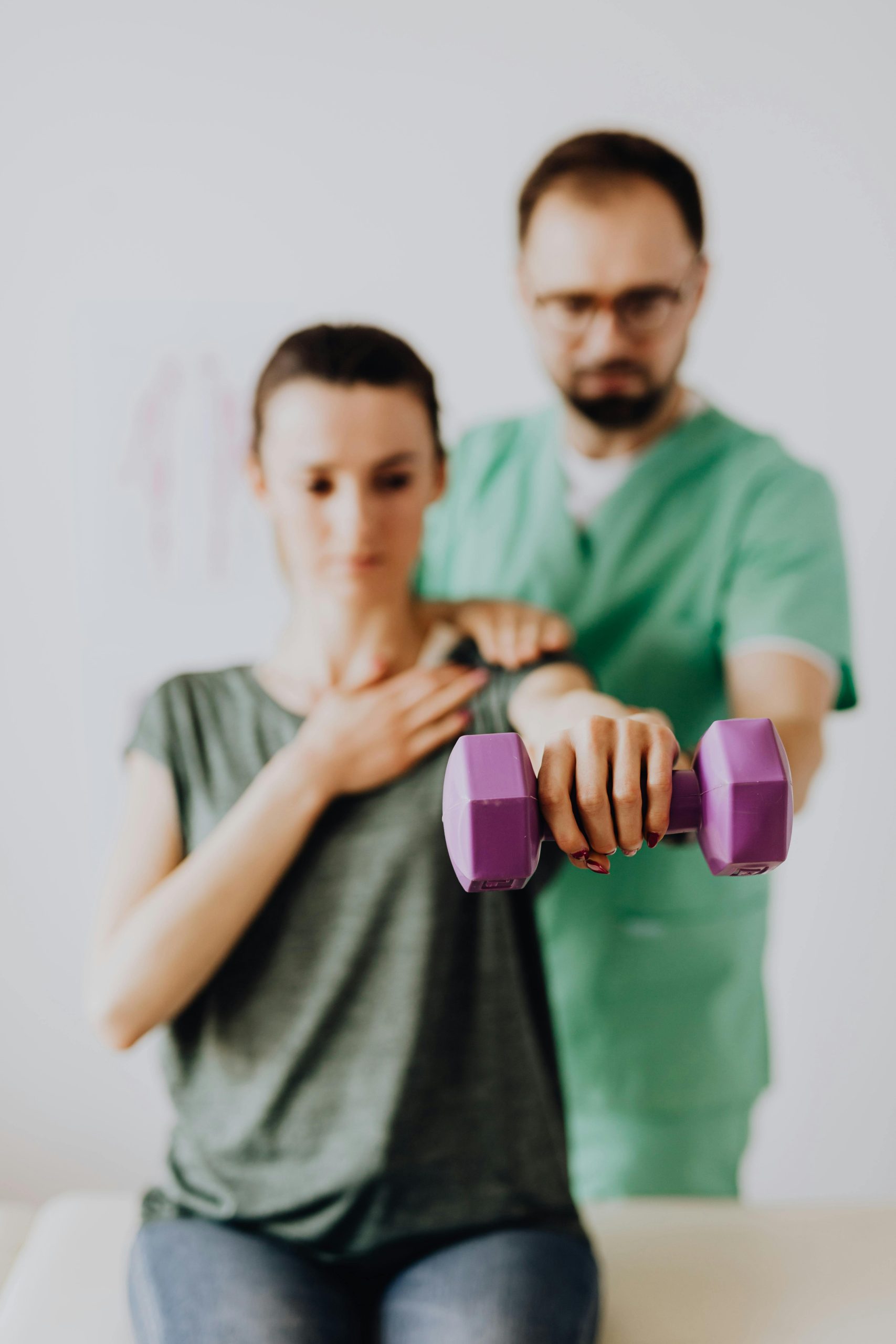 physical rehabilitation and chiropractic care dr helping woman lift weights